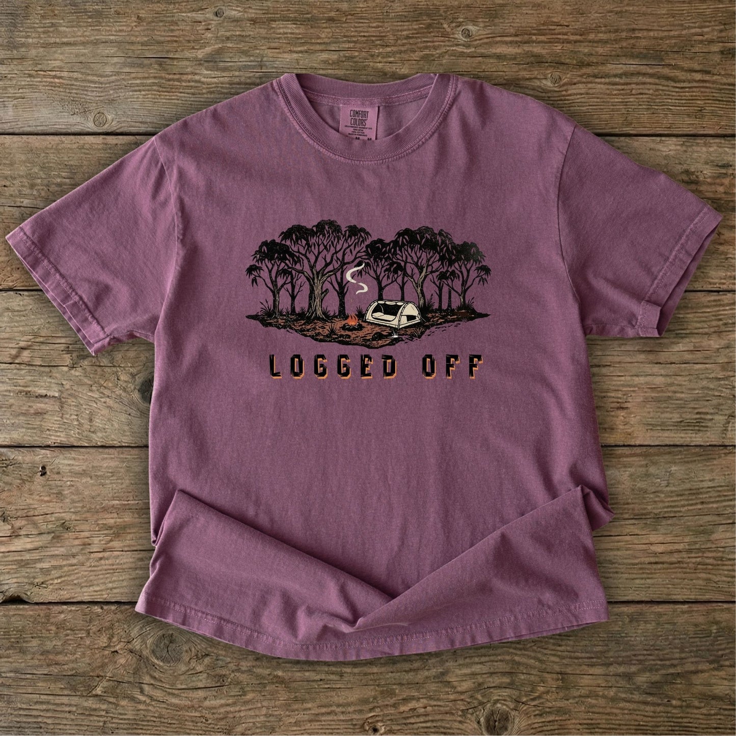 Logged Off camping shirt, t-shirt with a detailed screen-printed design of a smoking campfire and a dome tent nestled among towering Ghost Gums in the Australian bush.