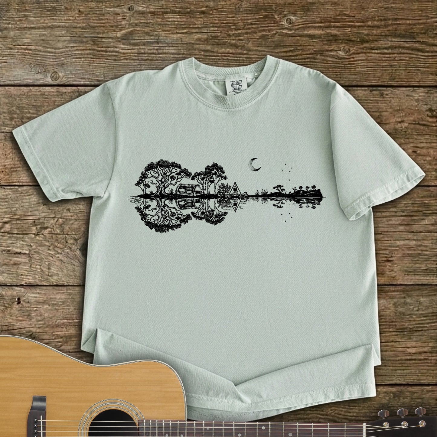 Bay Colour Southern Stars Guitar Tee featuring a lakeside campsite reflection in a guitar silhouette under an Australian night sky.