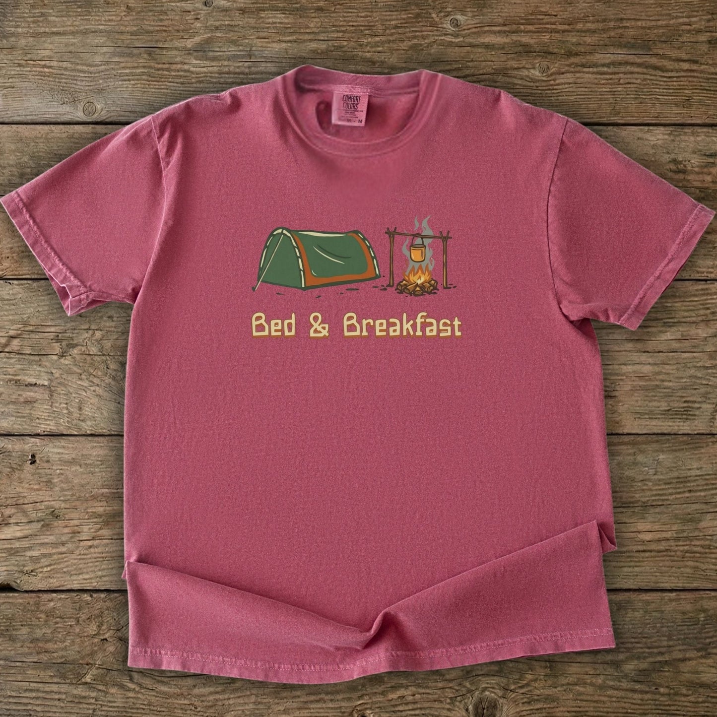 Brick Tee With Camp and Swag Graphic Print on a wooden background