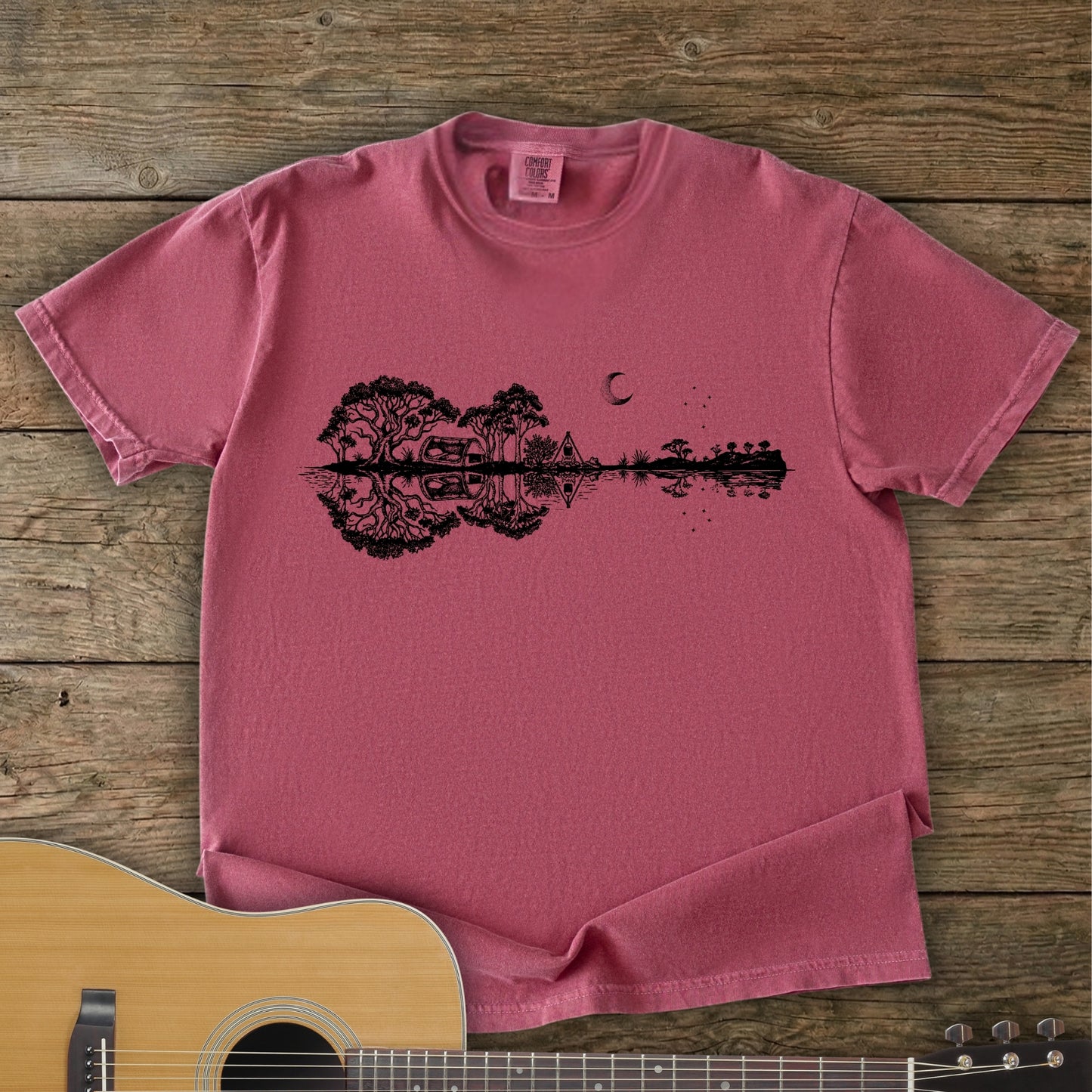 Brick Colour Southern Stars Guitar Tee featuring a lakeside campsite reflection in a guitar silhouette under an Australian night sky.