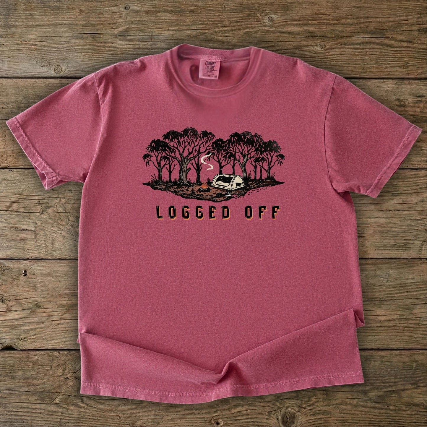 Logged Off camping shirt, t-shirt with a detailed screen-printed design of a smoking campfire and a dome tent nestled among towering Ghost Gums in the Australian bush.