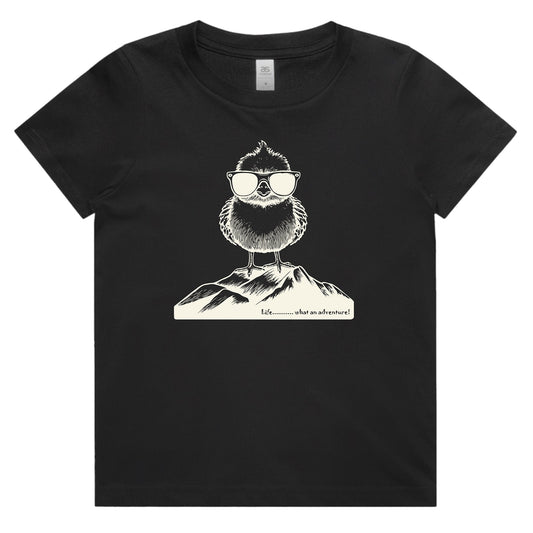 A black short-sleeve crewneck t-shirt featuring a white line art graphic of a bearded figure wearing sunglasses and a mountain, with the text 'What is adventure' printed below.