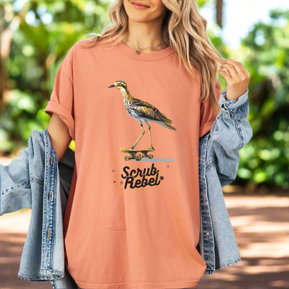 A Woman wearing a cute tshirt of a curlew bird on a skateboard