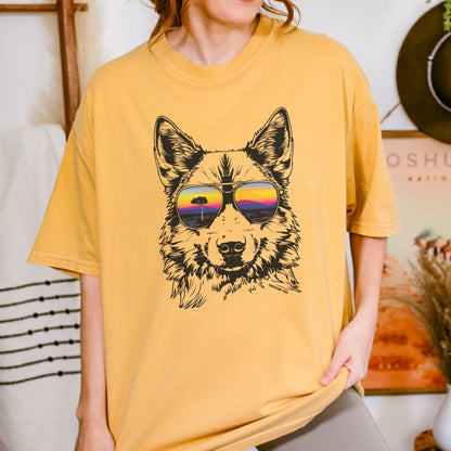 Woman wearing a mustard yellow t-shirt with a graphic of a dingo wearing sunglasses.