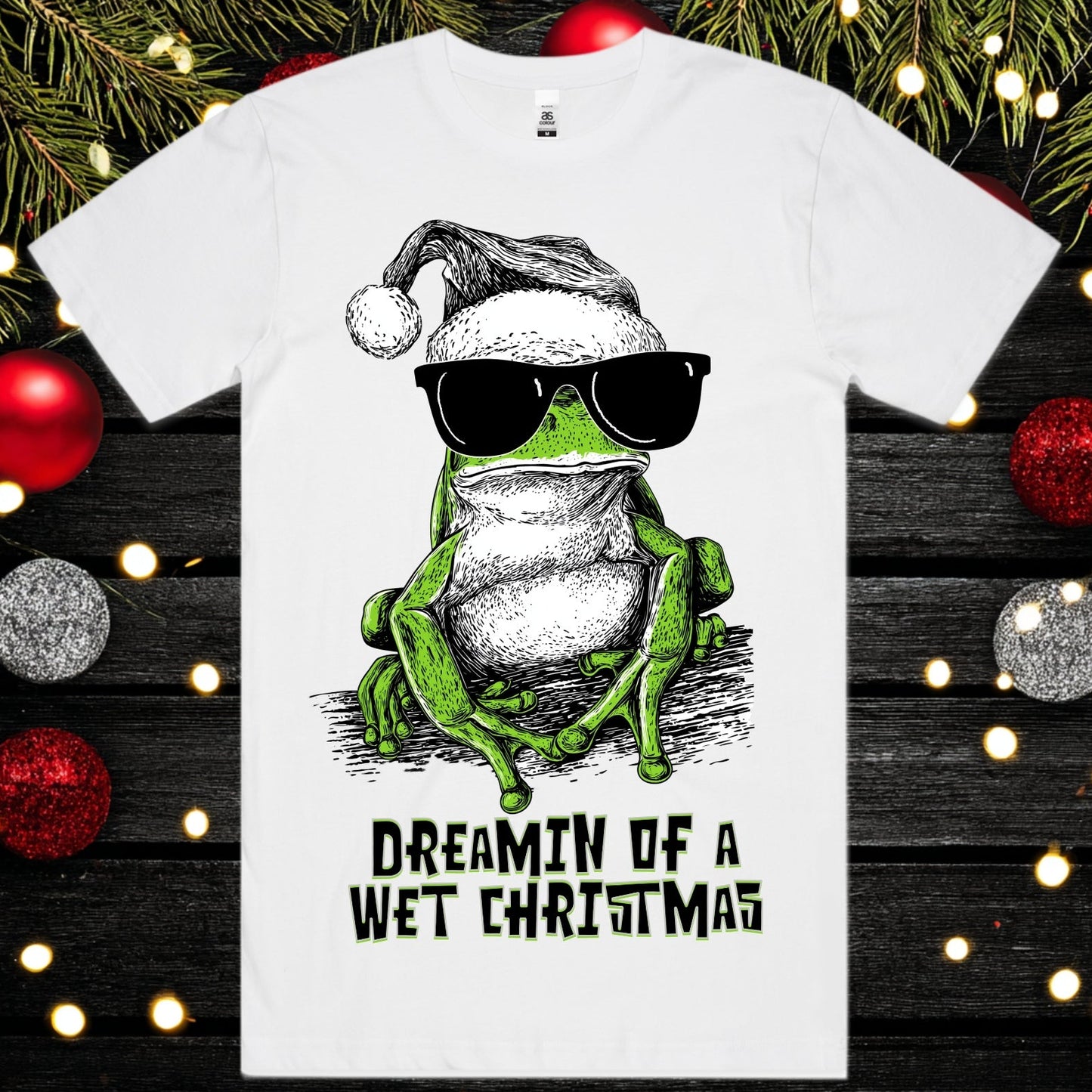 Dreamin of a wet christmas - Christmas Tee - Frog Tee Christmas Mockup on a background of christmas decorations