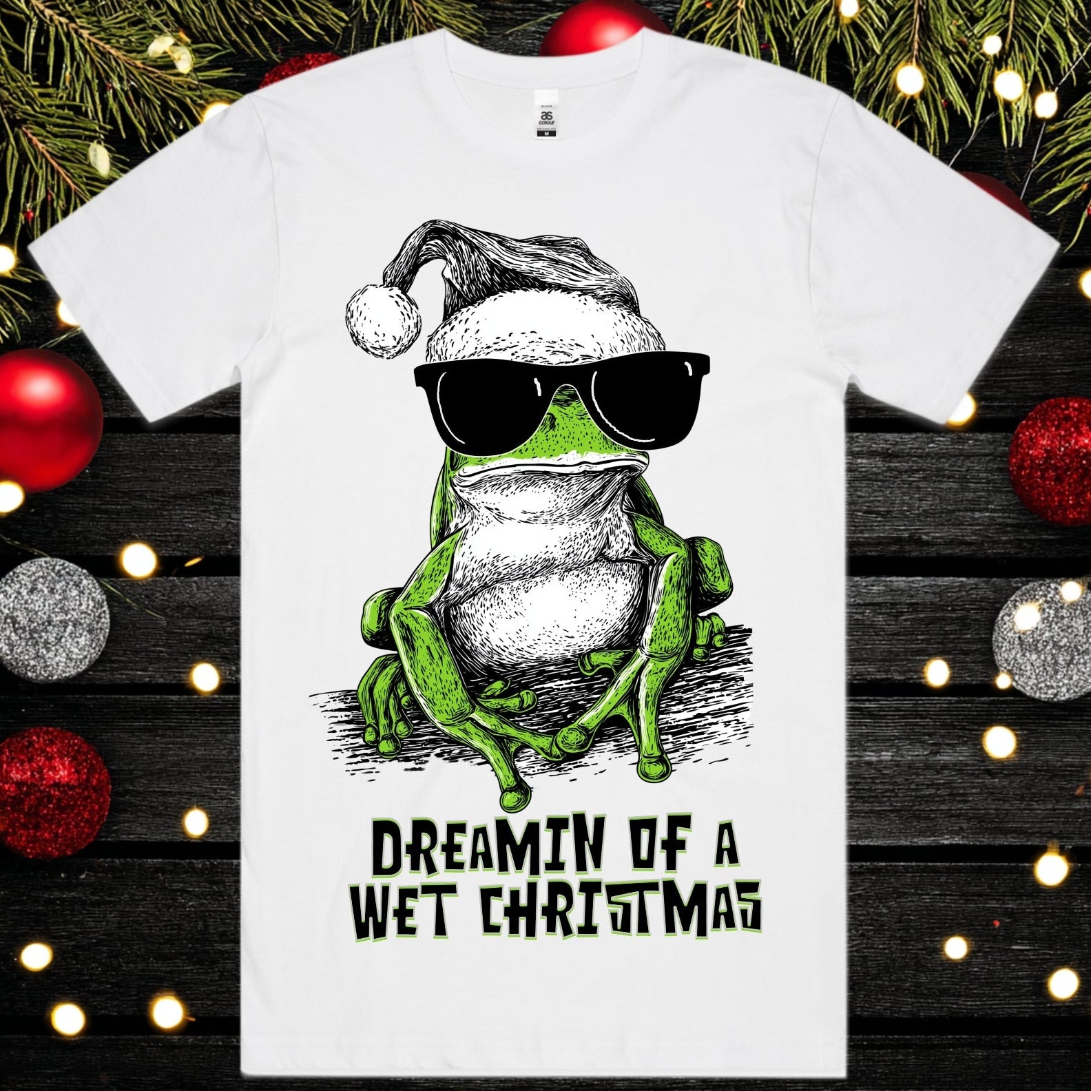 Dreamin of a wet christmas - Christmas Tee - Frog Tee Christmas Mockup on a background of christmas decorations