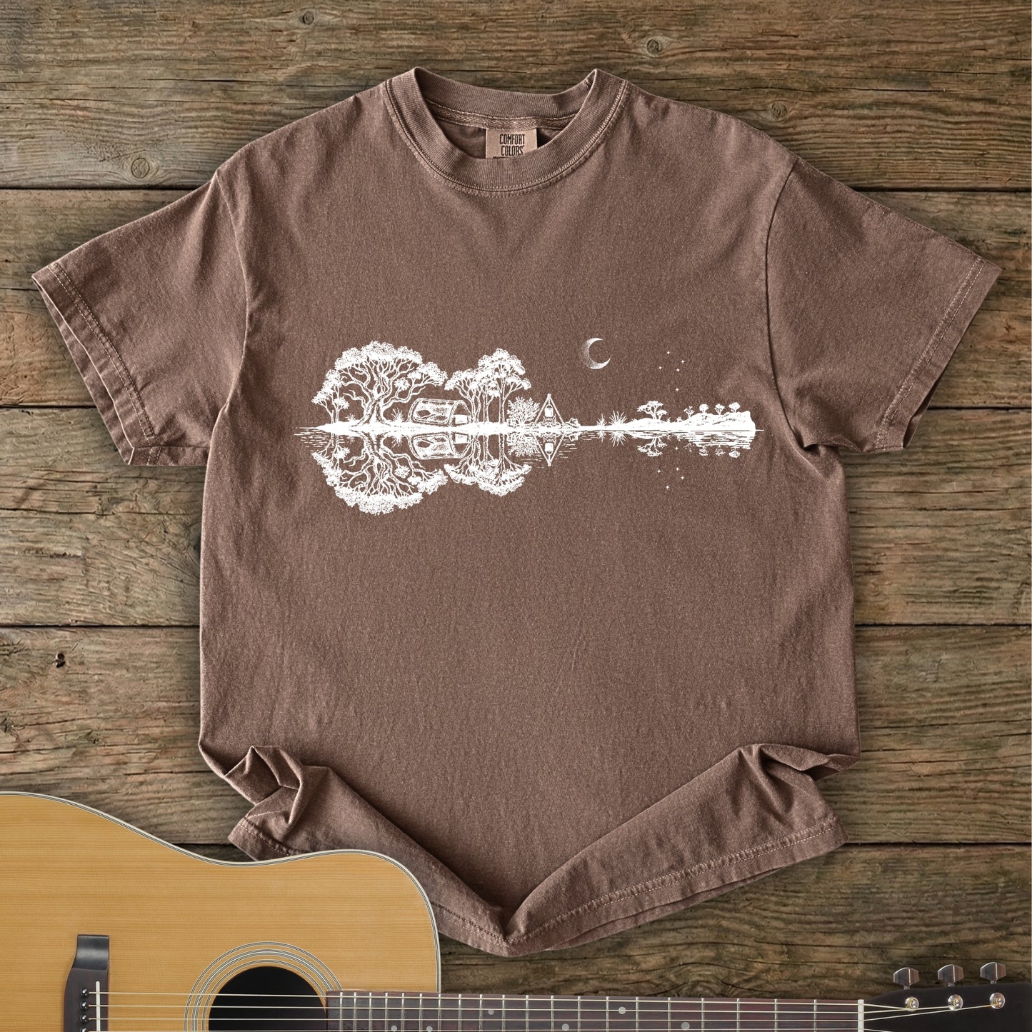 Southern Stars Guitar Tee featuring a lakeside campsite reflection in a guitar silhouette under an Australian night sky.