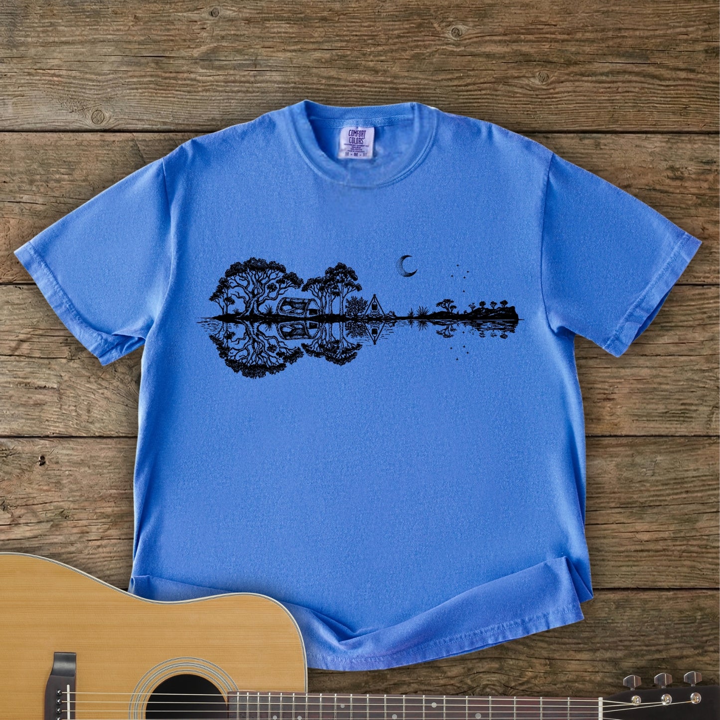 Flo Blue Southern Stars Guitar Tee featuring a lakeside campsite reflection in a guitar silhouette under an Australian night sky