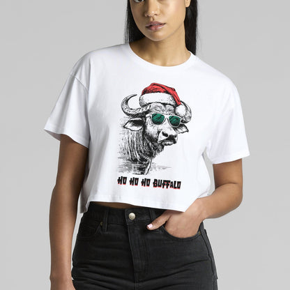 Woman wearing a white t-shirt with a graphic design of a buffalo wearing sunglasses and a Santa hat on a gray background.