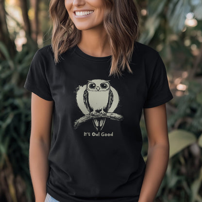 A smiling woman wearing a black women's fit T-shirt featuring the "It's Owl Good" design with a cute owl graphic.
