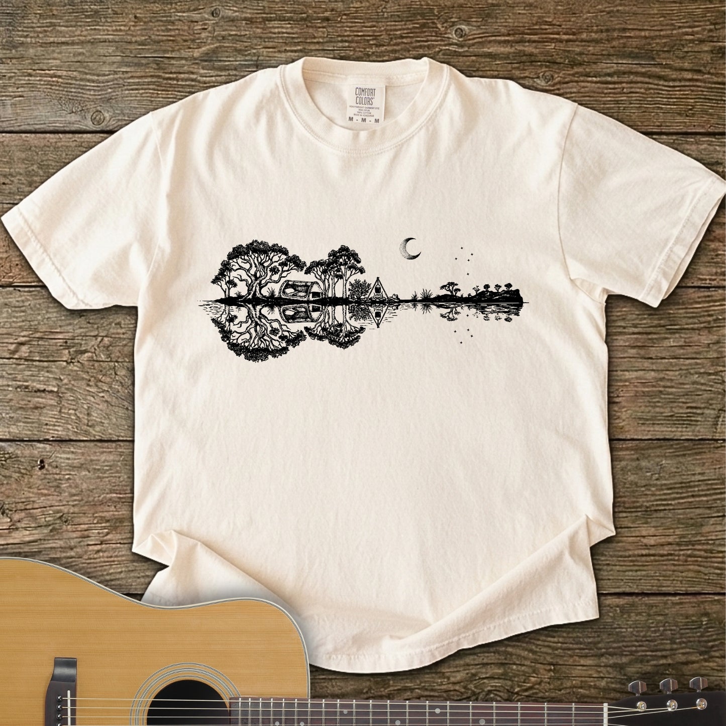 Ivory Colour Southern Stars Guitar Tee featuring a lakeside campsite reflection in a guitar silhouette under an Australian night sky.