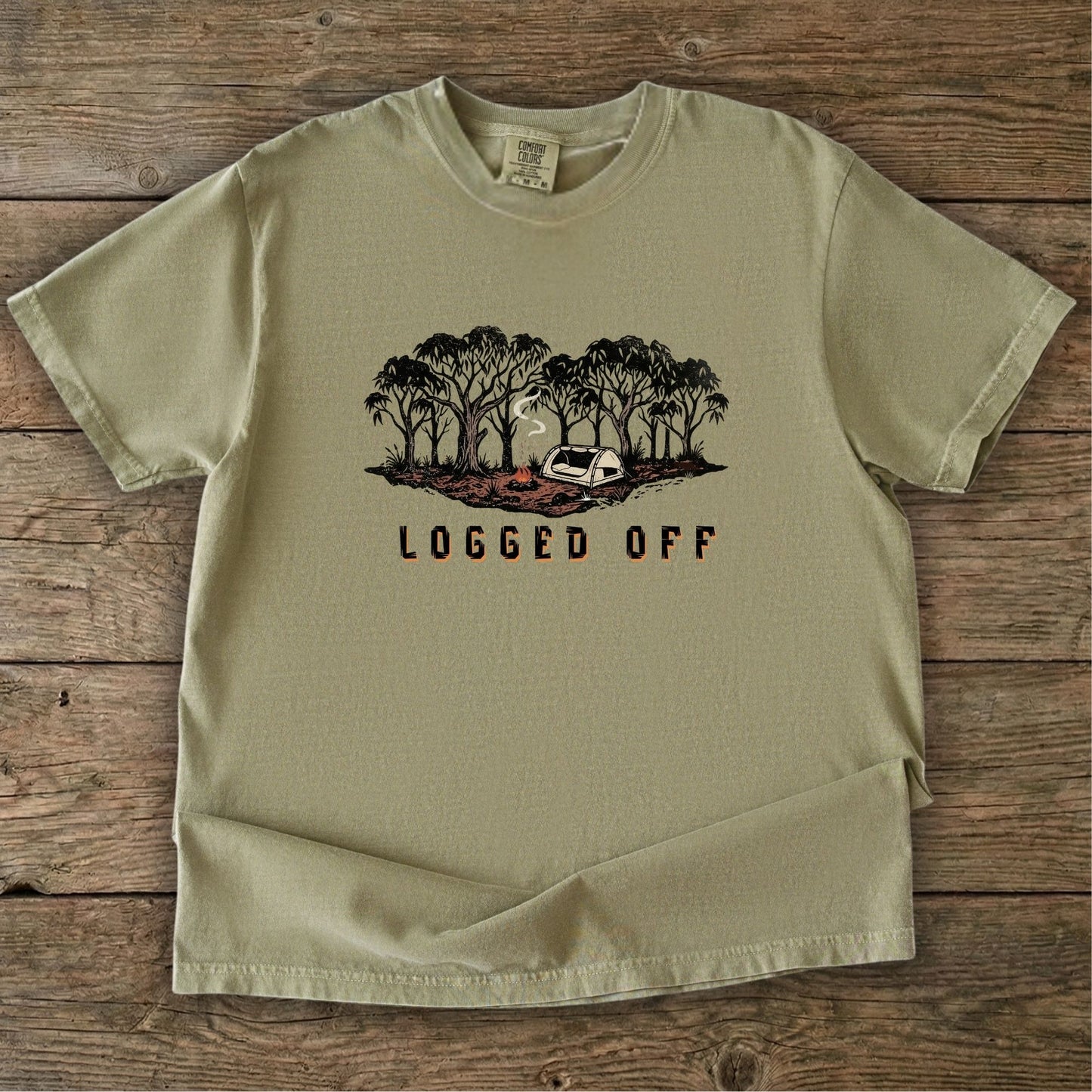 Logged Off camping shirt, t-shirt with a detailed screen-printed design of a smoking campfire and a dome tent nestled among towering Ghost Gums in the Australian bush.