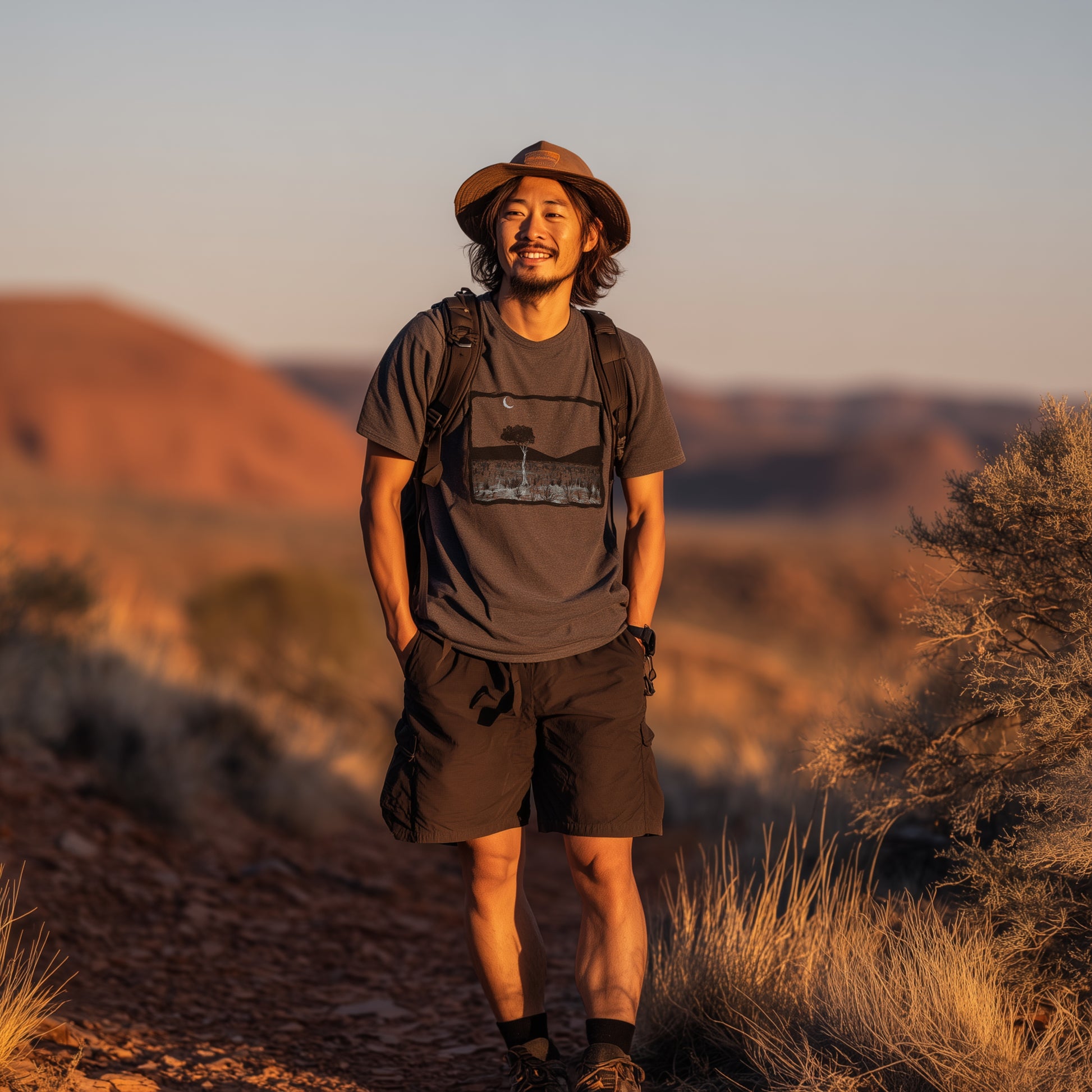 Larapinta Gum tree T-shirt worn by a hiker on the larapinta trail setting in late evening sun