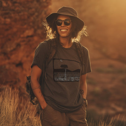 Larapinta walk gum tree and mountain range tshirt worn by a lady in the fading sunlight in central australia