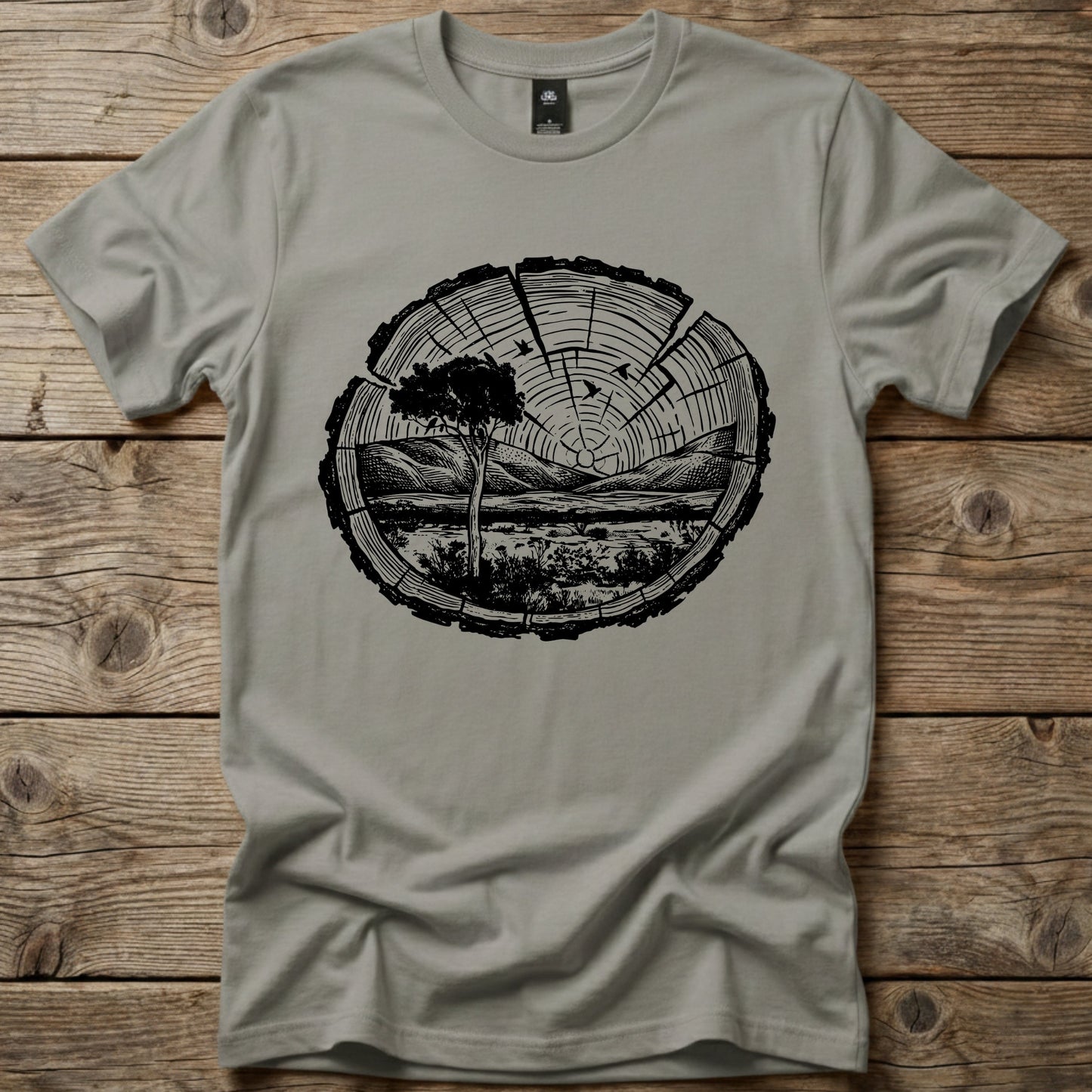 Granite Grey Ghost Gum Tees t-shirt featuring a black wood slice graphic containing an Australian outback landscape, a Larapinta gum tree, and distant mountains.