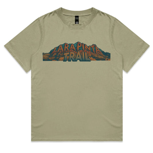 An olive green short-sleeve t-shirt with a graphic print on the chest reading 'LARAPINTA TRAIL' in stylized orange and blue lettering over a mountain illustration, displayed flat against a white background.