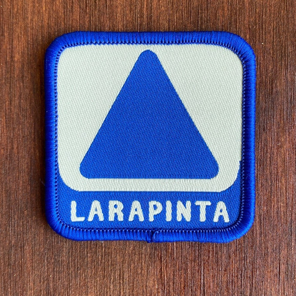 Larapinta Trail patch iron-on badge featuring the iconic blue triangular trail marker used on the Larapinta Trail in Australia's Northern Territory