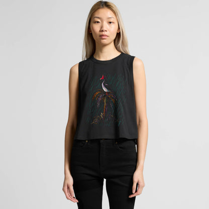 Woman wearing a crop tank top with a magpie goose graphic design on a plain background