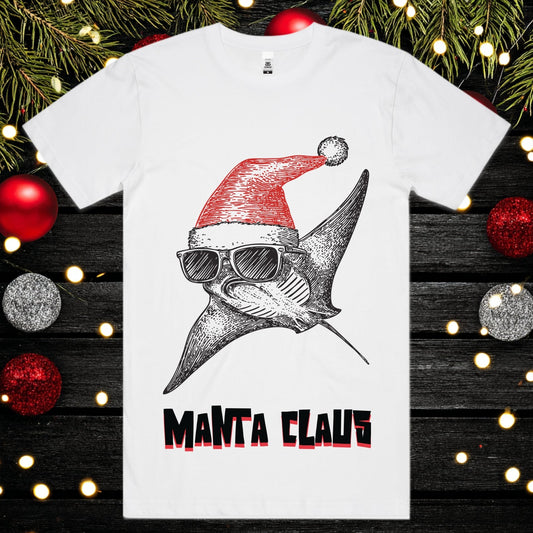 White t-shirt with a manta ray wearing a Santa hat and sunglasses, labeled 'Manta Claus', on a festive background with Christmas decorations.
