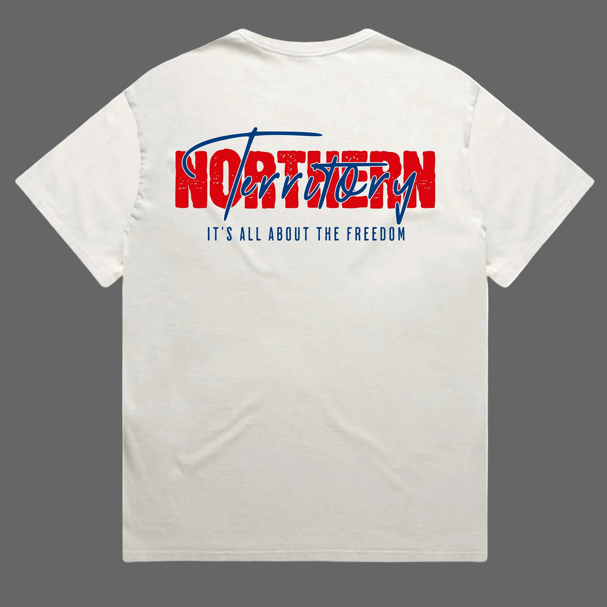 An off-white crewneck t-shirt shown from the back, featuring a graphic print with the word 'NORTHERN' in distressed red block letters and 'Territory' in blue script, with the slogan 'IT'S ALL ABOUT THE FREEDOM' printed below in blue.