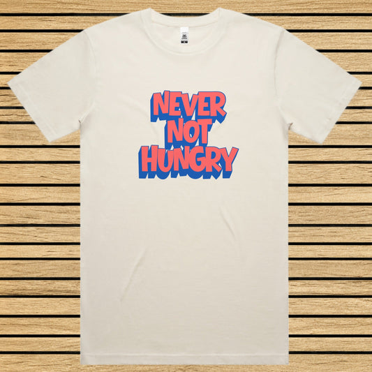 Ecru t-shirt with 'NEVER NOT HUNGRY' text in blue and red on a wooden slat background