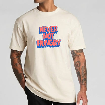Man wearing a ecru t-shirt with 'NEVER NOT HUNGRY' text in red and blue on a gray background