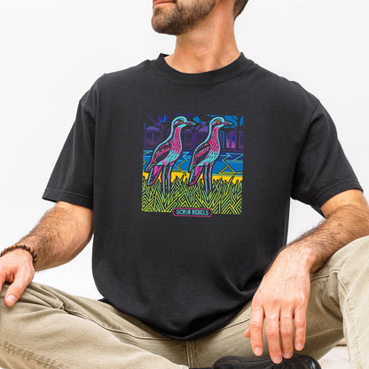 Person wearing a black t-shirt with colorful curlew graphic design sitting on a white background