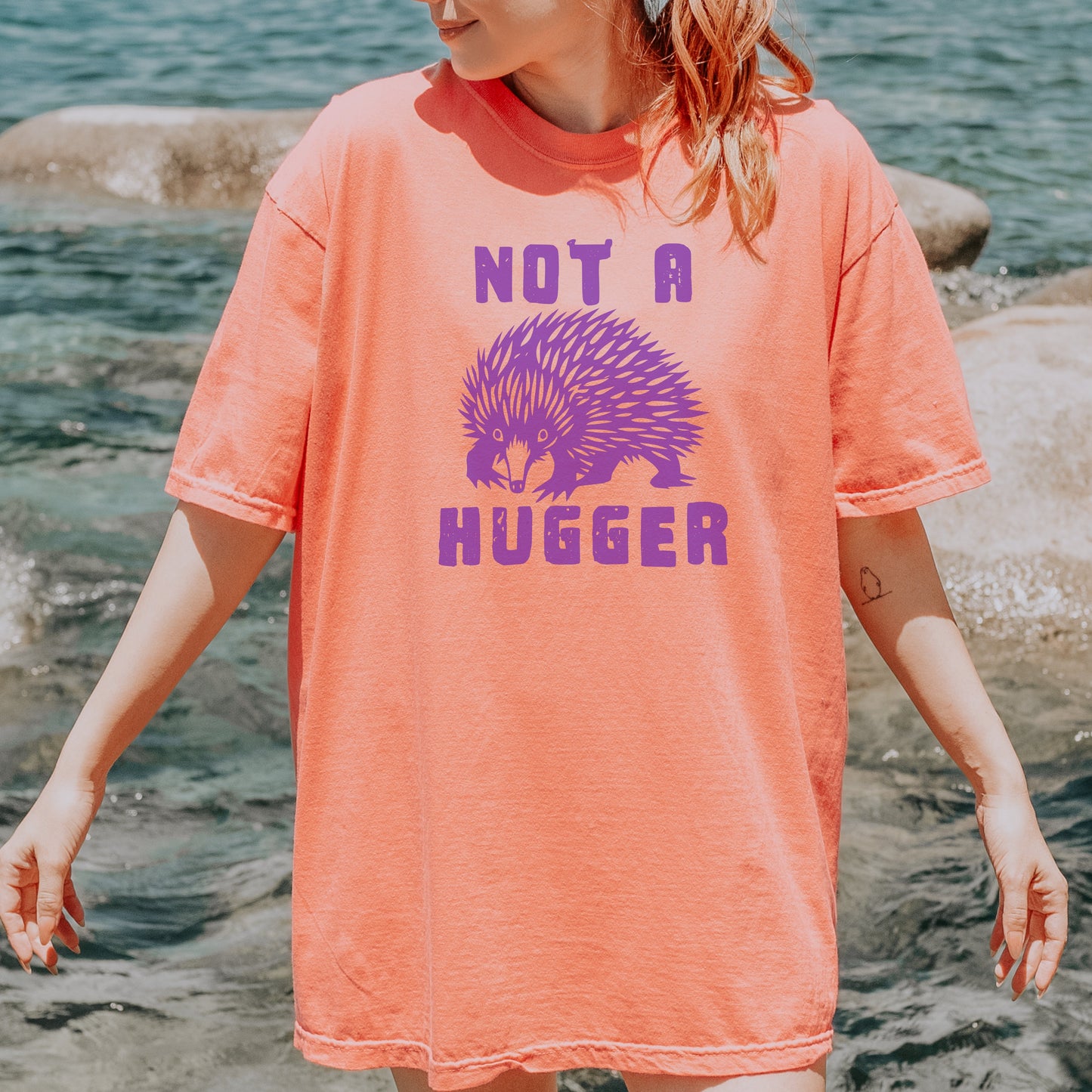 Girl wearing Not a hugger tee, in terracotta colour