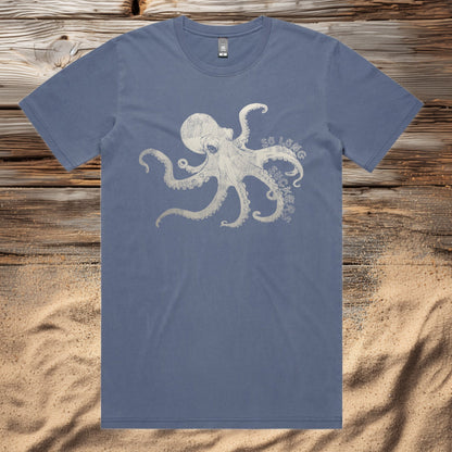 Faded Blue t-shirt with an octopus design on a wooden surface