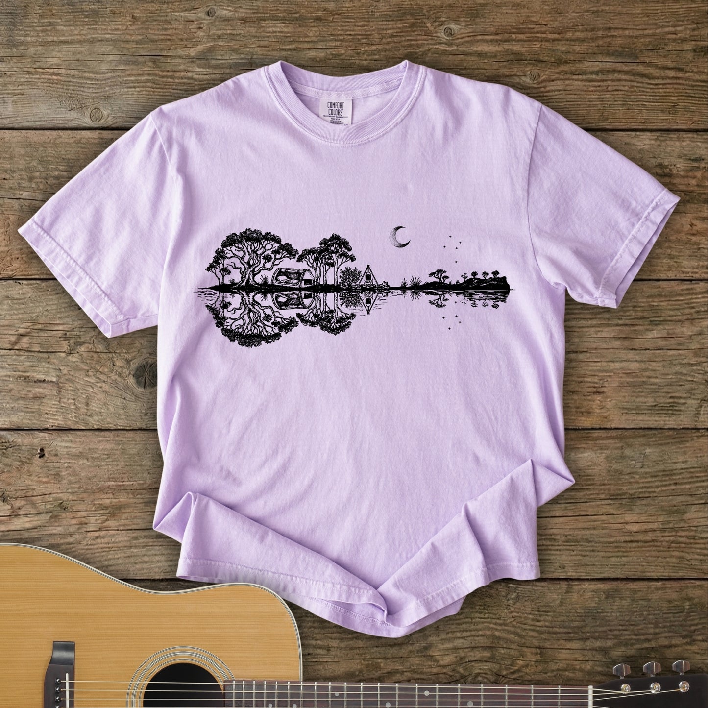 Orchid Southern Stars Guitar Tee featuring a lakeside campsite reflection in a guitar silhouette under an Australian night sky.