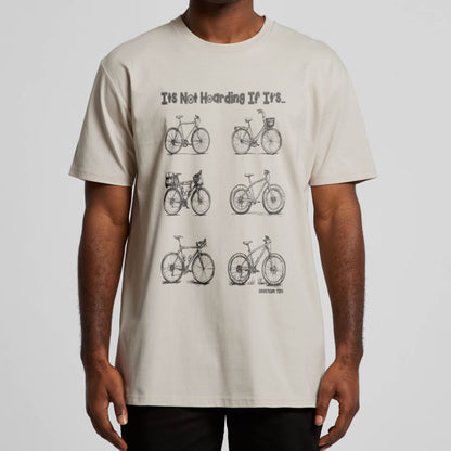 A guy wearing a off white t-shirt with the print " It's Not Hoarding if its Bicycles" printed on it