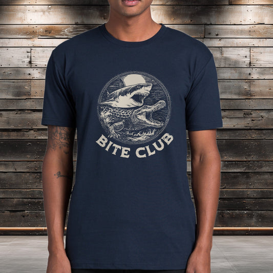 Croc and Shark graphic tee with the words " Bite Club " printed below the graphic. Man is wearing the Navy version of Tshirt