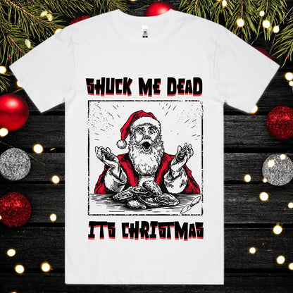 White t-shirt with a graphic of Santa Claus and text 'Shuck Me Dead It's Christmas' on a festive background.