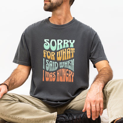 Person wearing a t-shirt with a humorous text design sitting on a white background