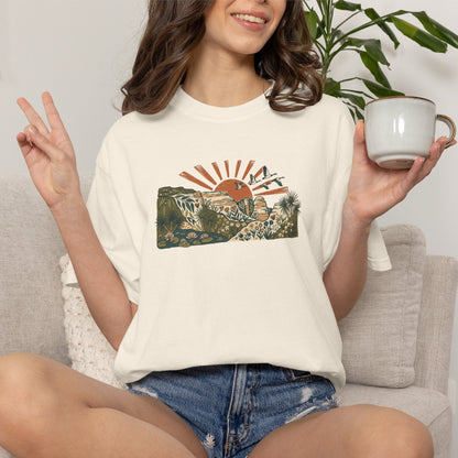 Billabong Sunrise T-shirt featuring an Australian wetland landscape, native plants, rocky escarpment, flying birds and a warm orange sunrise.