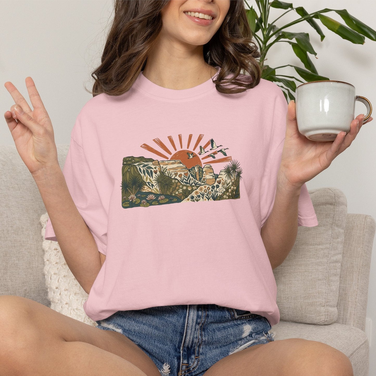 Billabong Sunrise T-shirt featuring an Australian wetland landscape, native plants, rocky escarpment, flying birds and a warm orange sunrise.
