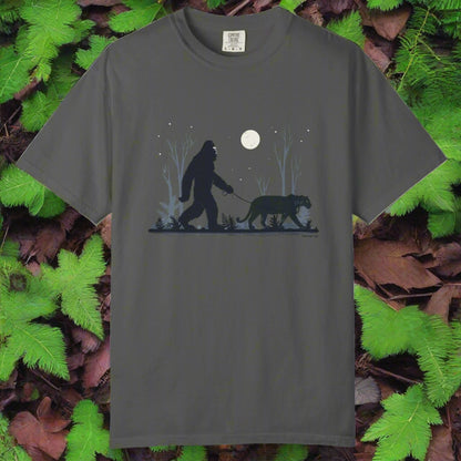 Gray t-shirt with a graphic of a bigfoot and a panther walking under a moonlit sky.