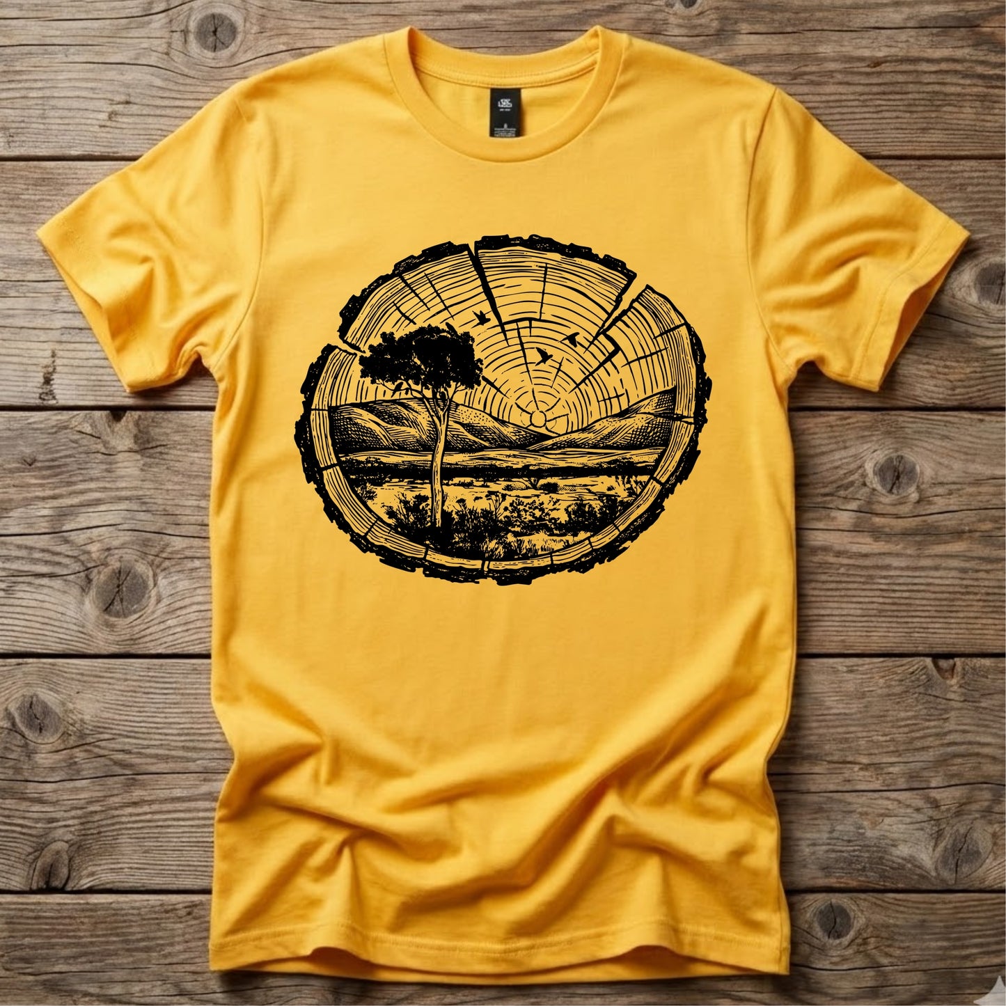 Yellow Ghost Gum Tees t-shirt featuring a black wood slice graphic containing an Australian outback landscape, a Larapinta gum tree, and distant mountains.