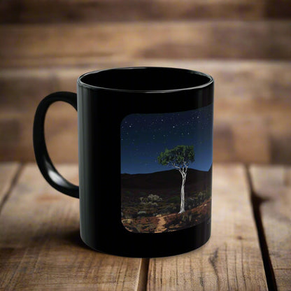 Larapinta Trail black mug featuring a night scene with a ghost gum tree under a starry sky in the Australian outback