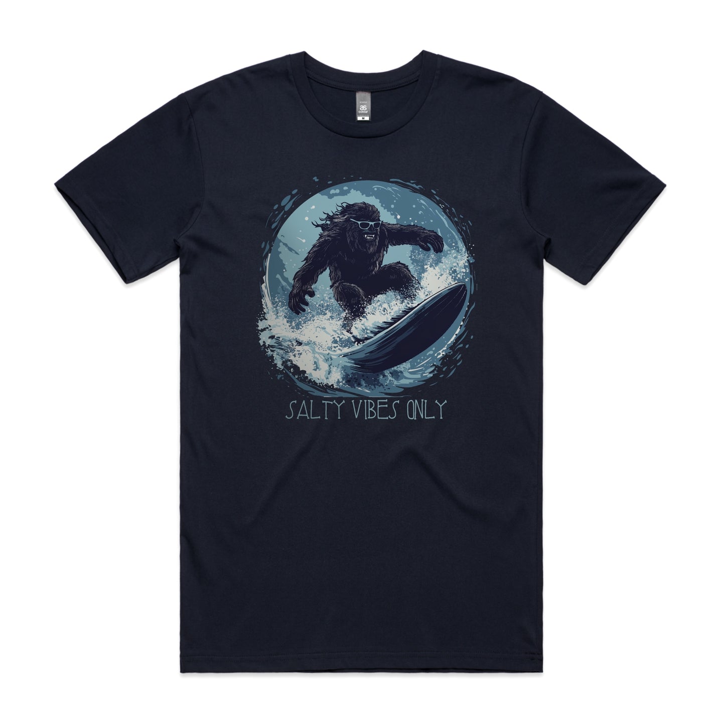 Bigfoot surfing graphic on navy AS Colour Staple Tee with the phrase "Salty Vibes Only" – surf-inspired bigfoot design